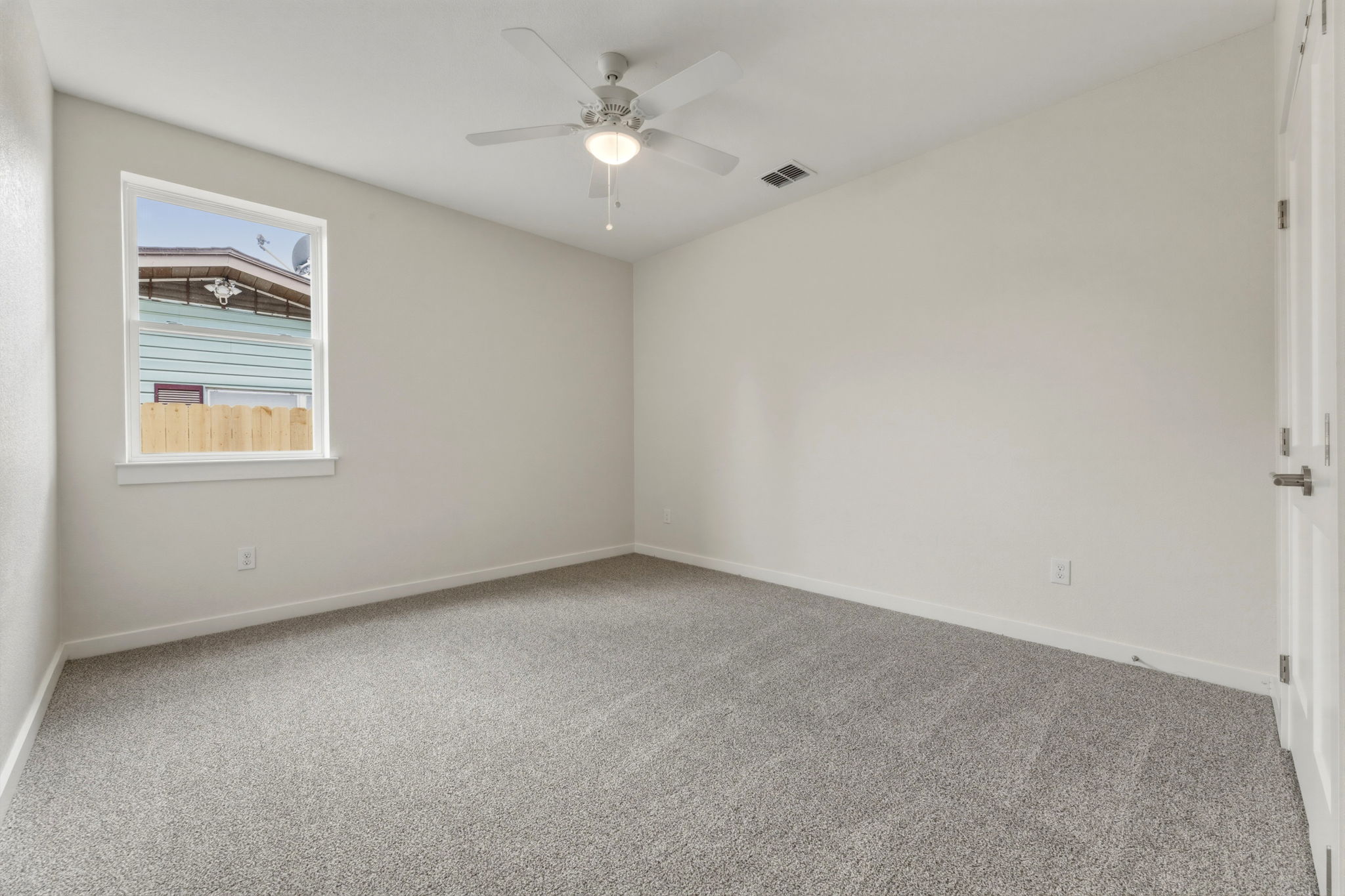 1412 Kent Street Taylor, TX 76574 - Photo 5 of 40 an empty room with a window and a ceiling fan