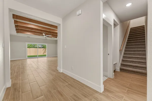 a view of empty room with wooden floor