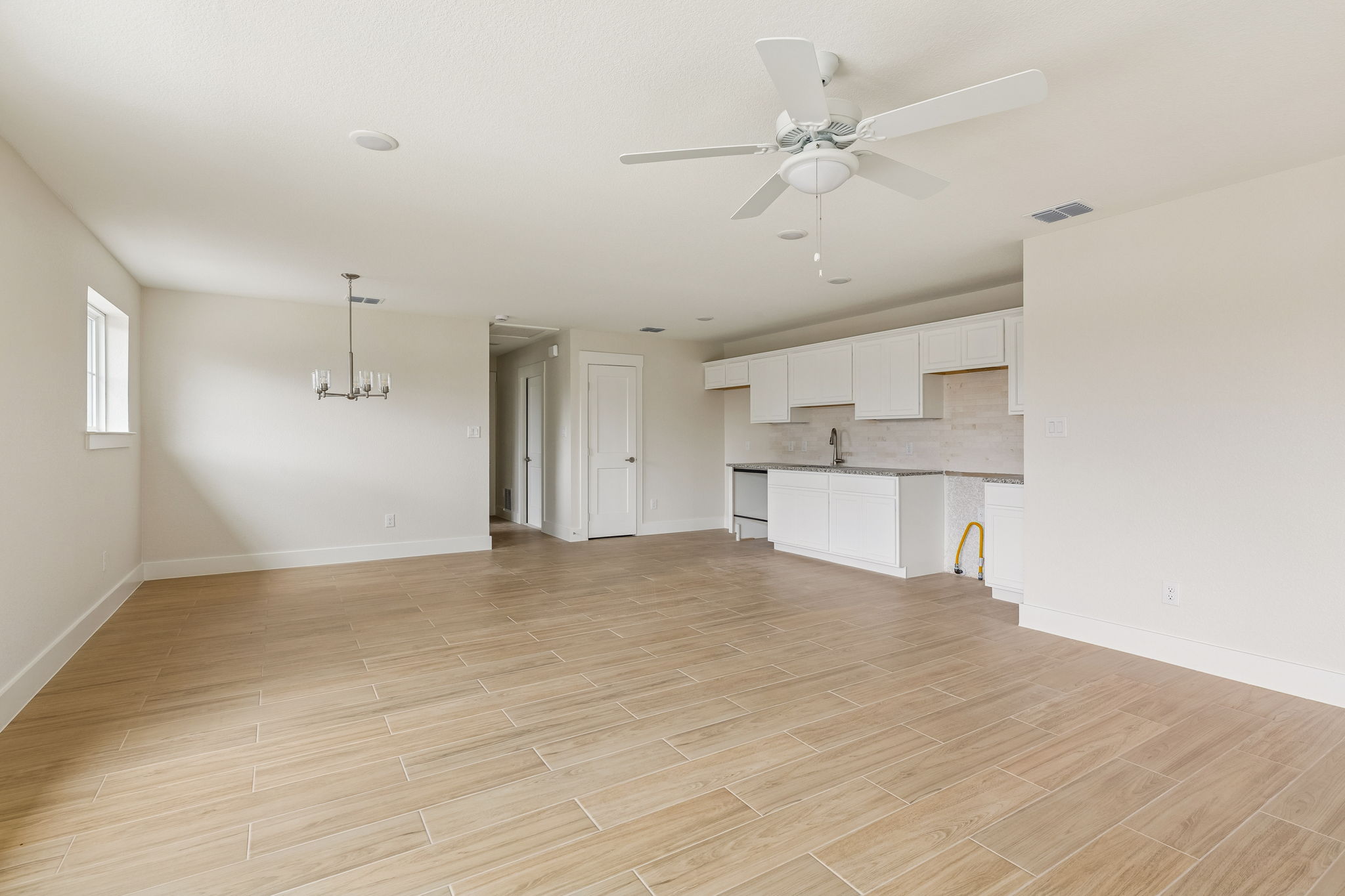 1412 Kent Street Taylor, TX 76574 - Photo 8 of 12 Guest Quarters - view from living room looking at kitchen and dining.