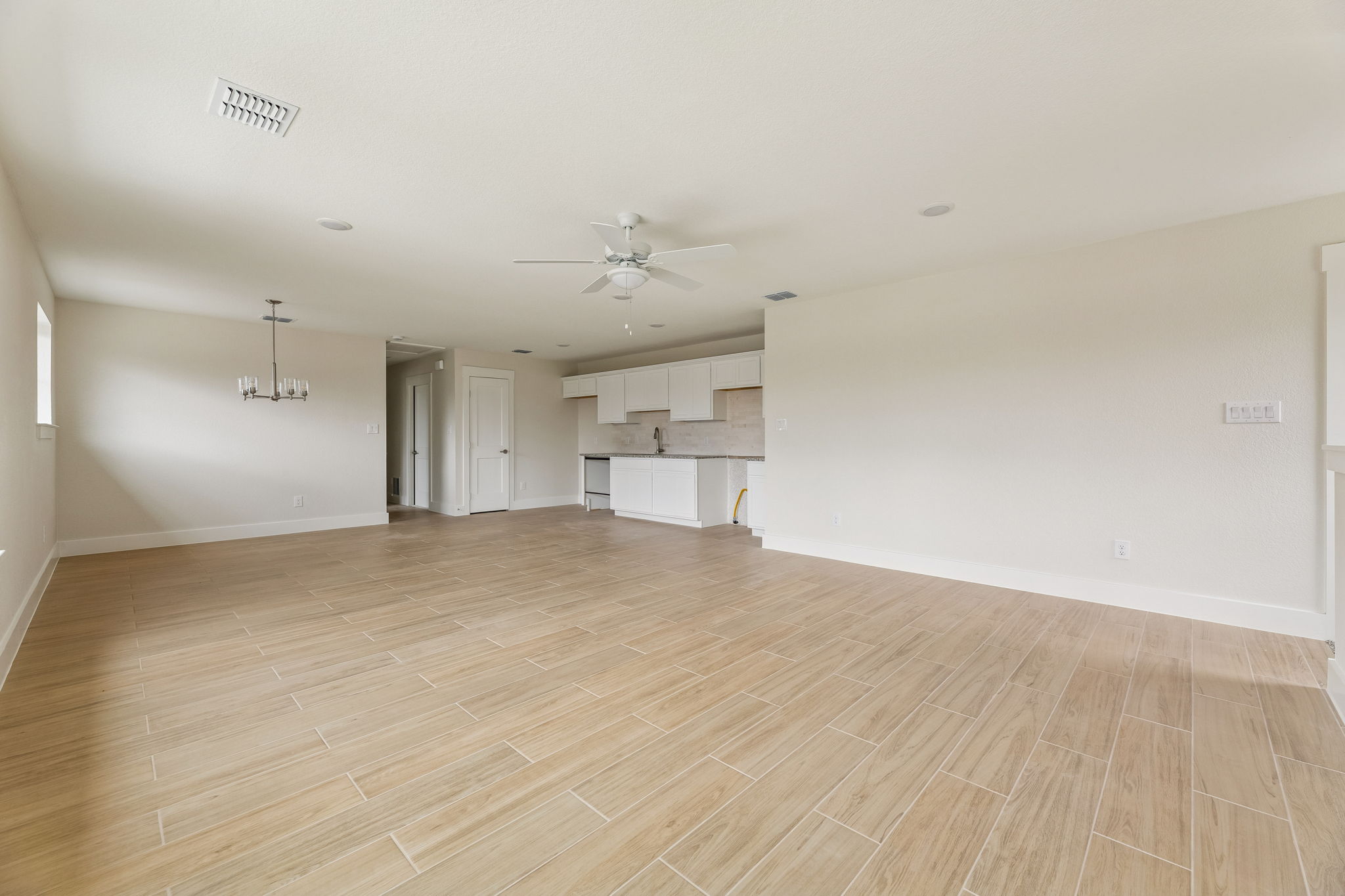 1412 Kent Street Taylor, TX 76574 - Photo 9 of 12 Guest Quarters - view from living room looking at kitchen and dining.