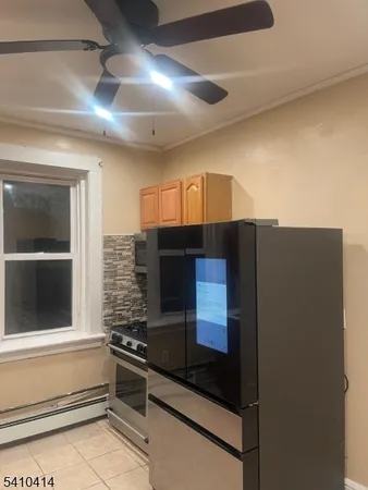 a kitchen with stainless steel appliances granite countertop a refrigerator and a stove