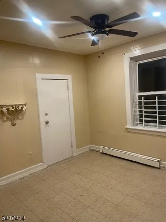 an empty room with a empty space and a ceiling fan