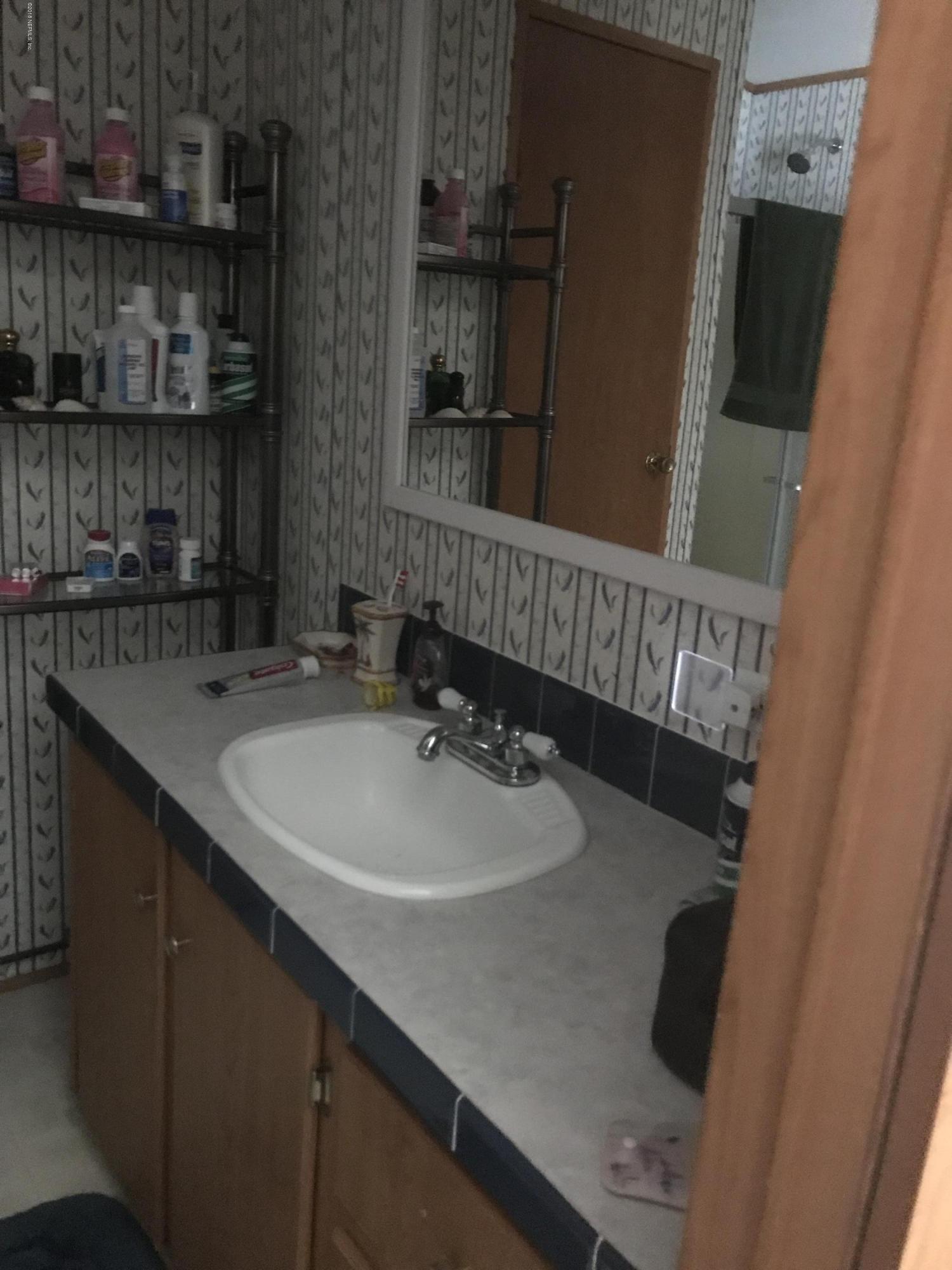 96541 Chester Road Yulee, FL 32097 - Photo 11 of 20 a bathroom with a sink and a mirror