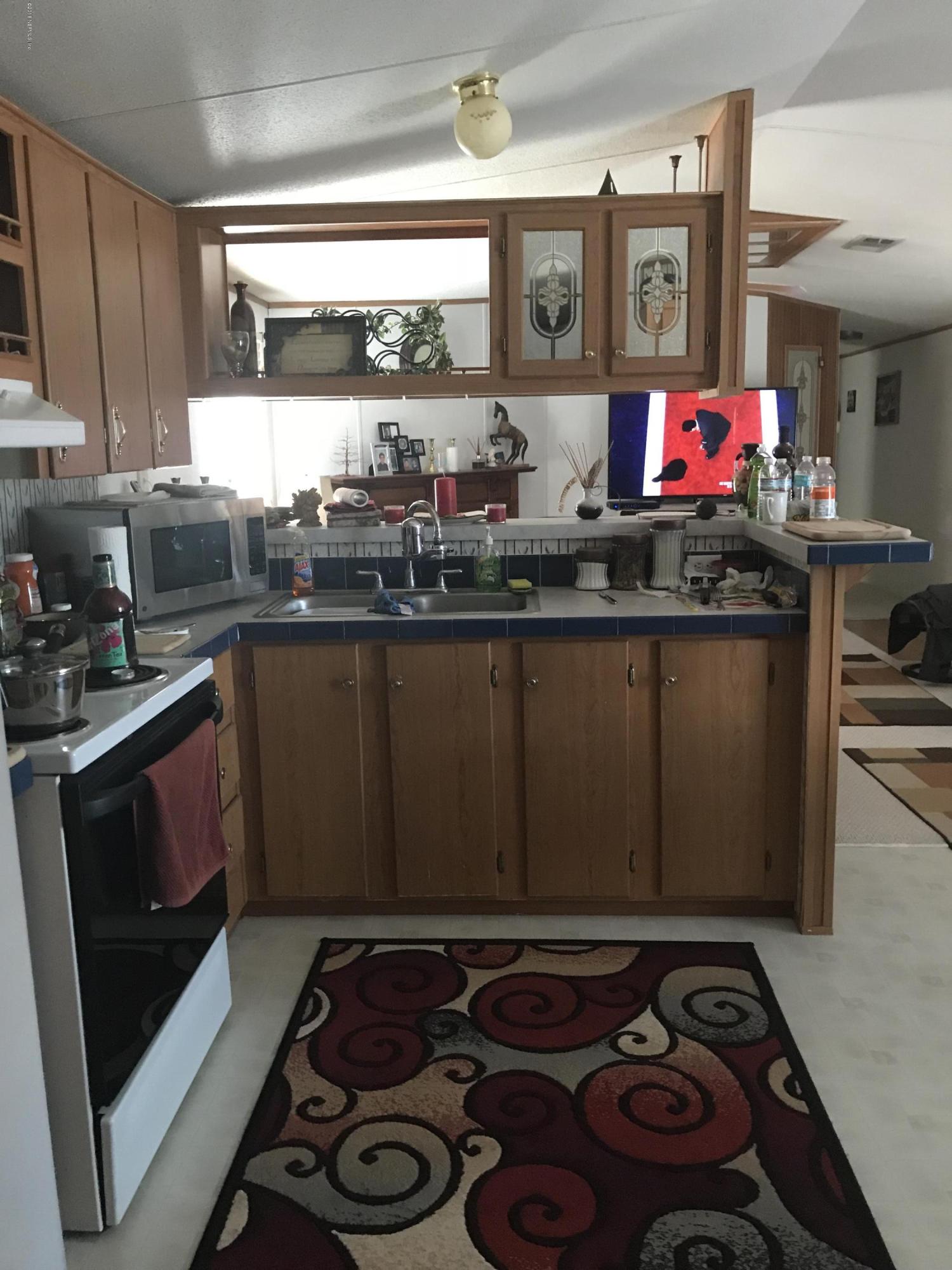 96541 Chester Road Yulee, FL 32097 - Photo 13 of 20 a kitchen with stainless steel appliances granite countertop a stove and cabinets