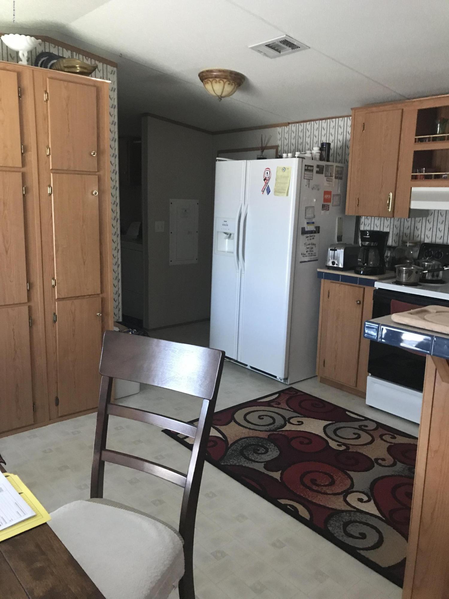 96541 Chester Road Yulee, FL 32097 - Photo 14 of 20 a kitchen with stainless steel appliances granite countertop a refrigerator and a stove