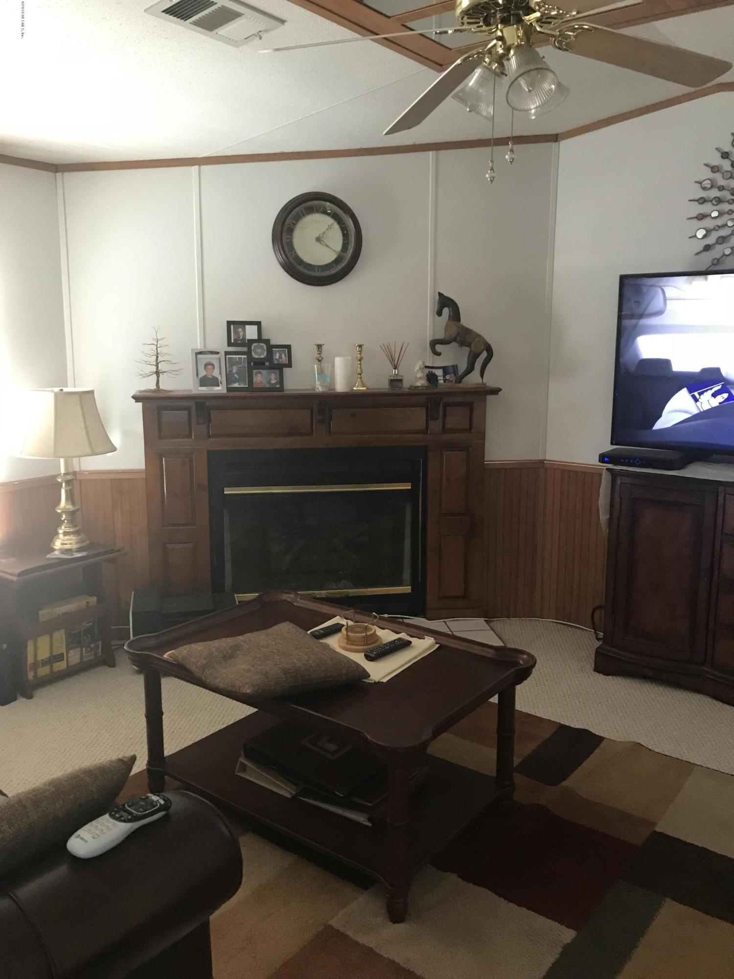 96541 Chester Road Yulee, FL 32097 - Photo 16 of 20 a living room with furniture and a fireplace