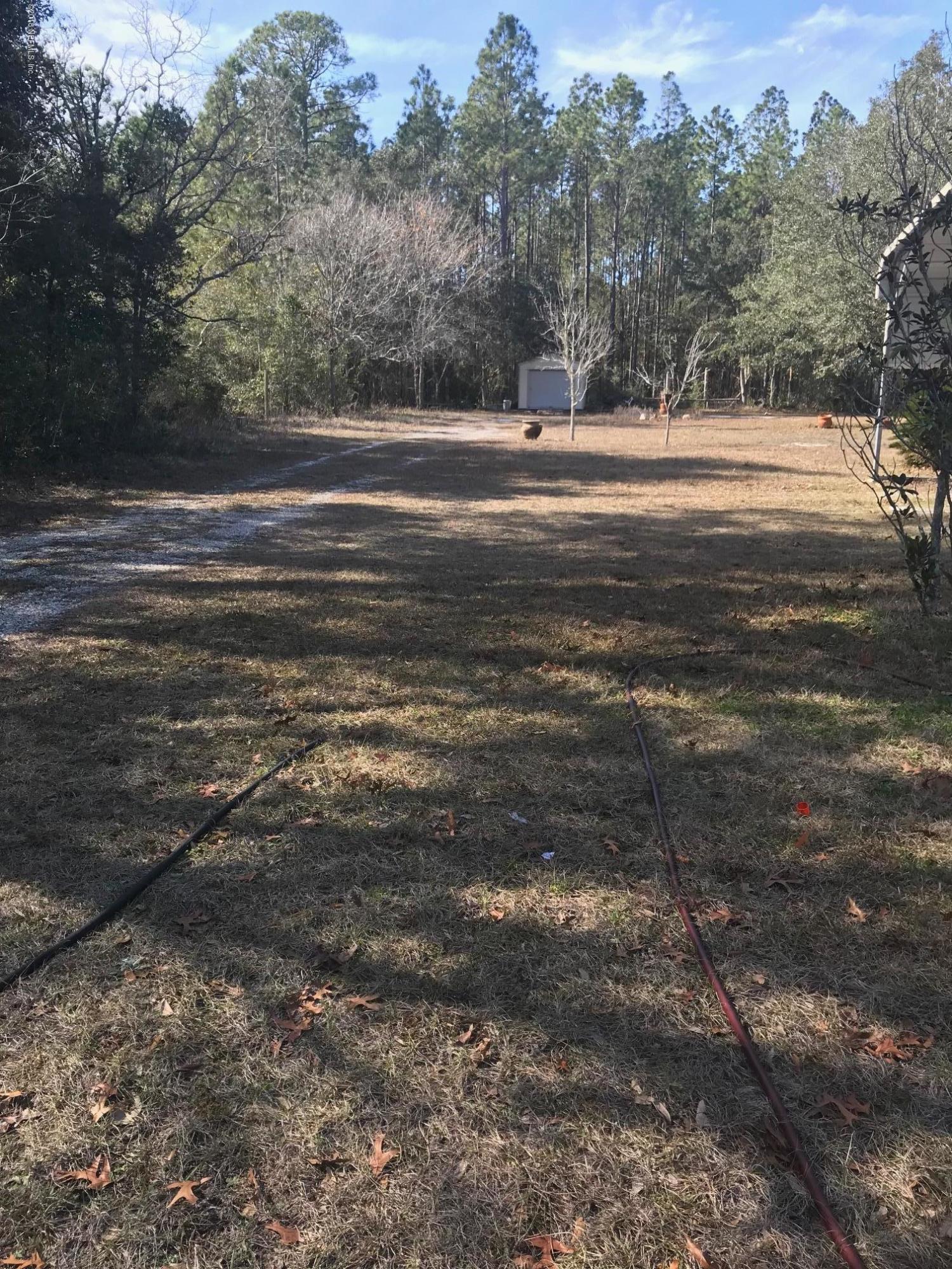 96541 Chester Road Yulee, FL 32097 - Photo 5 of 20 a view of a field with trees in the background