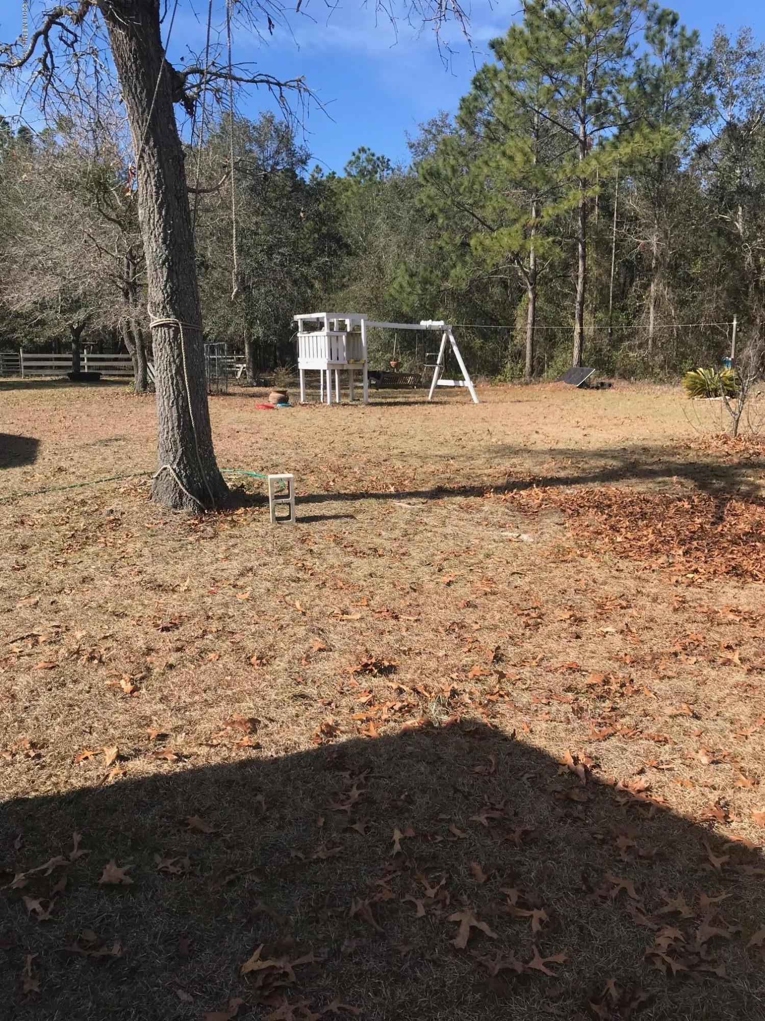 96541 Chester Road Yulee, FL 32097 - Photo 7 of 20 a backyard of a house with lots of green space