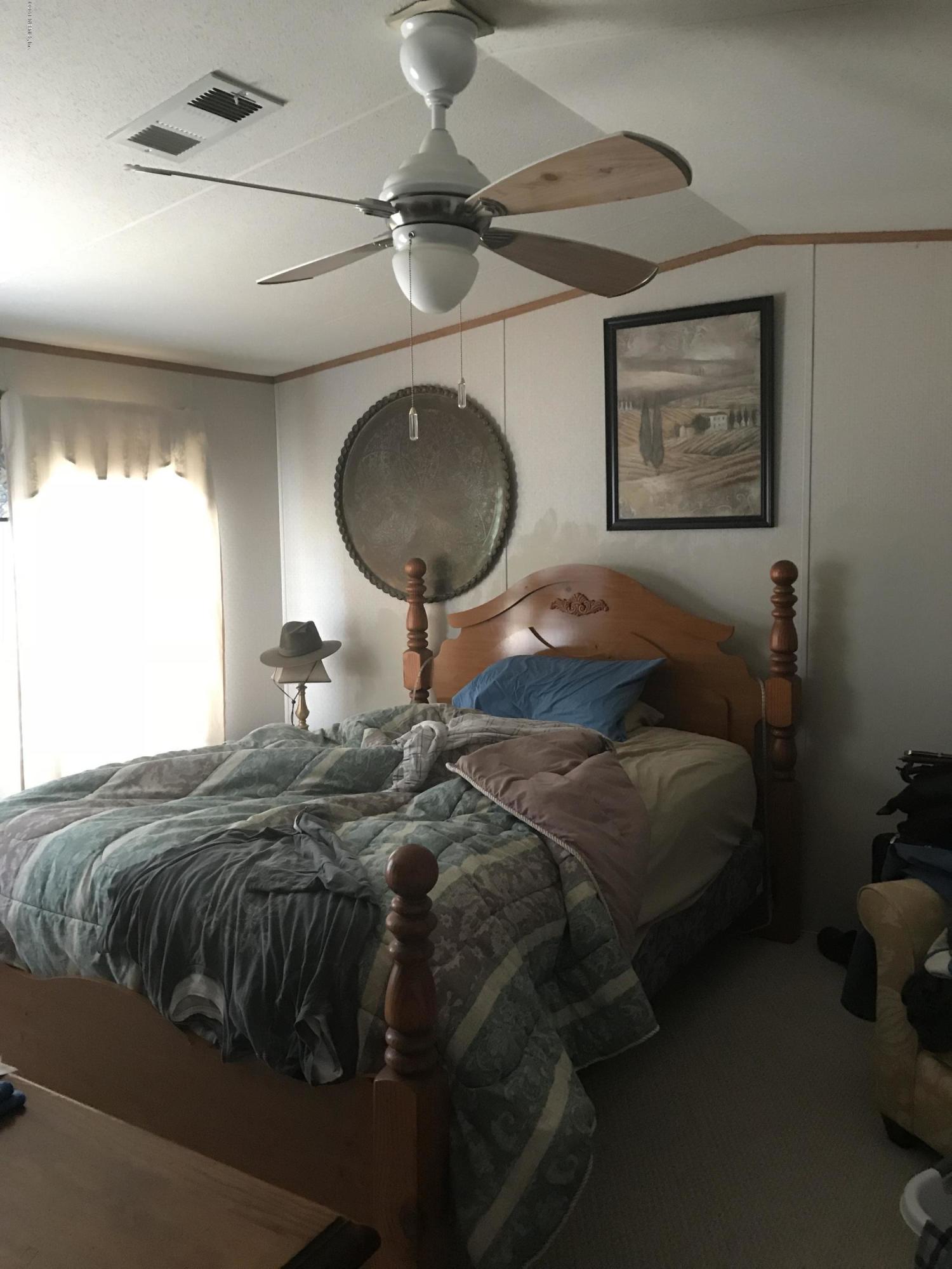 96541 Chester Road Yulee, FL 32097 - Photo 9 of 20 a bedroom with a bed and a chandelier