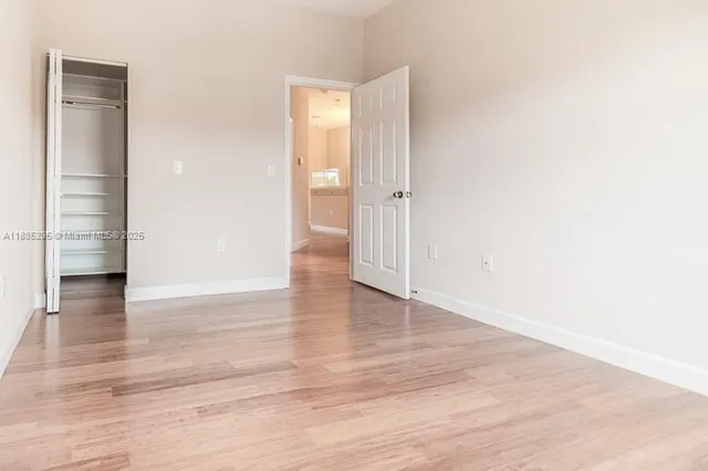 a view of walk in closet with empty racks