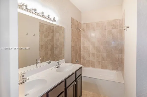 a view of a kitchen with wooden floor and a ceiling fan