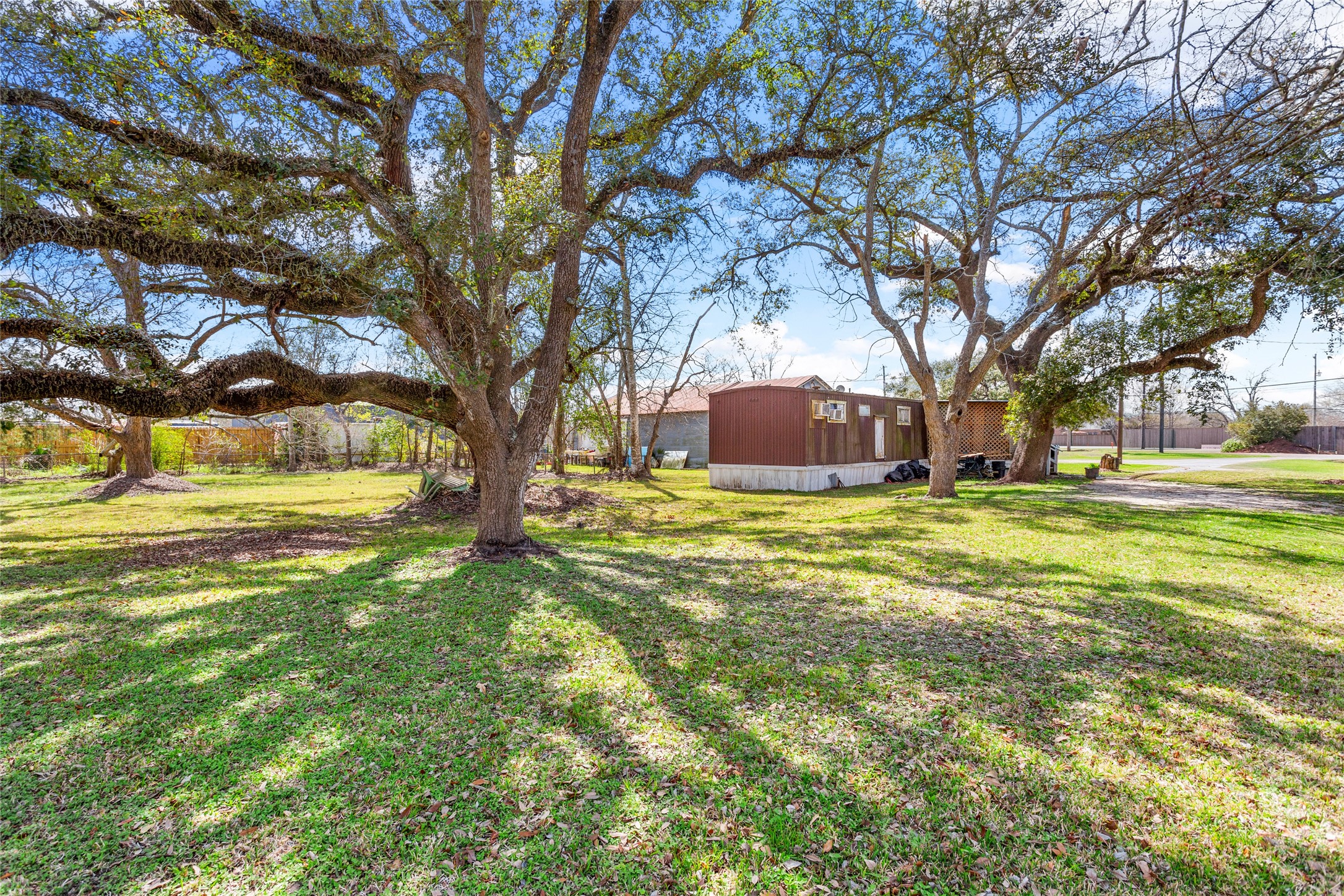 1806 FM 528 Road Alvin, TX 77511 - Photo 12 of 17 a view of a house with a large trees