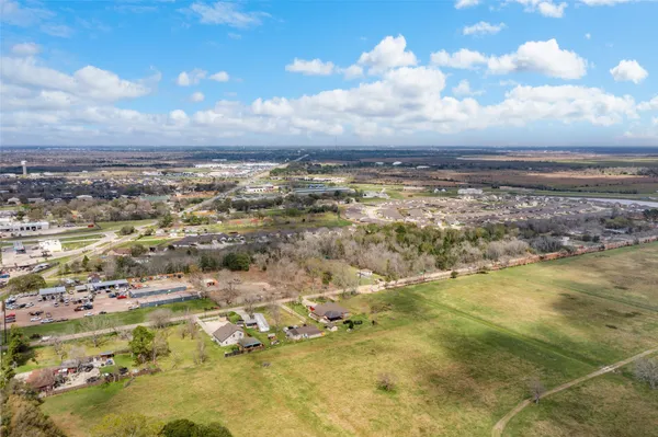 a view of a street with a building and trees in the background