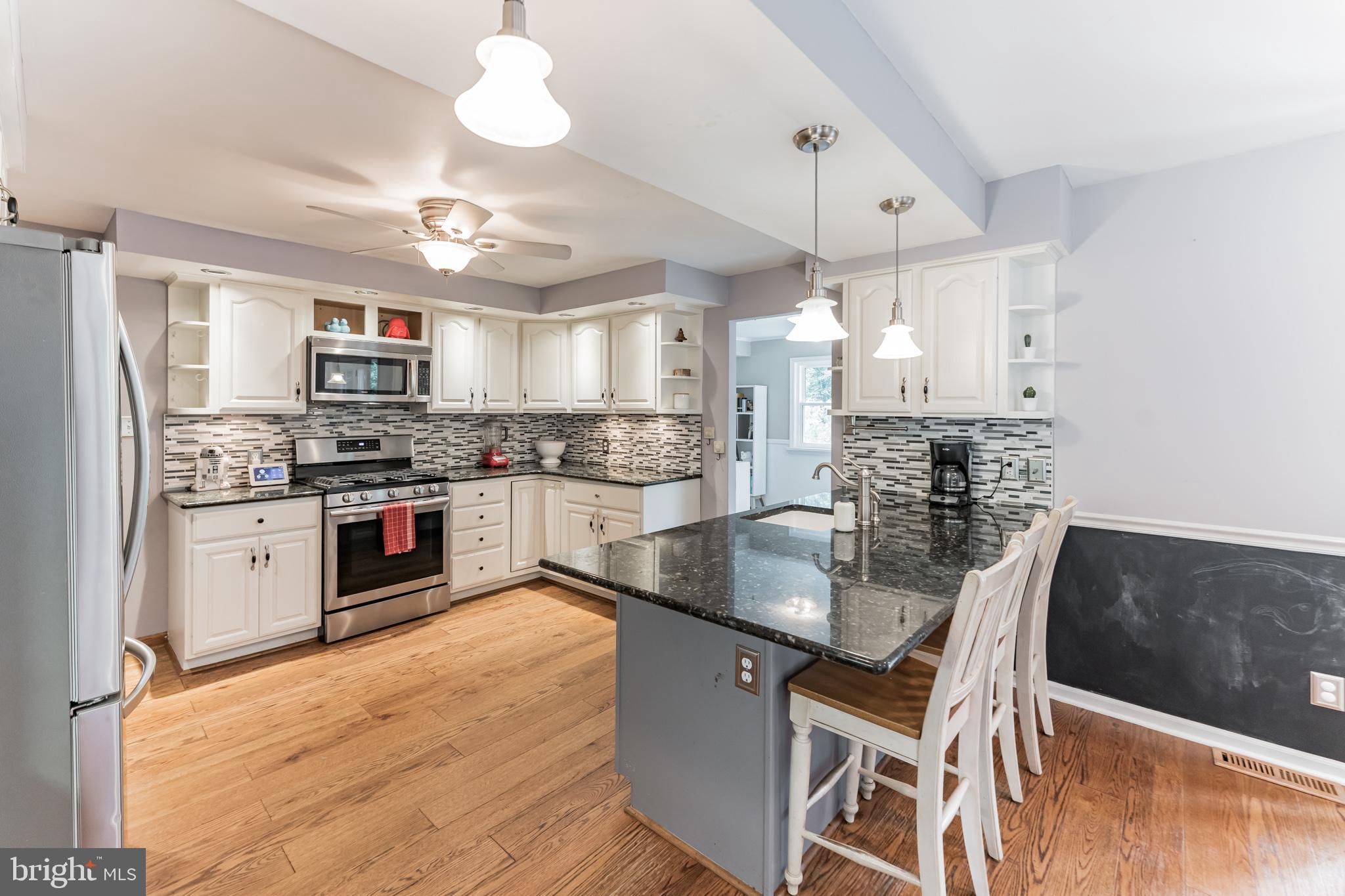 1070 Dale Road Media, PA 19063 - Photo 13 of 40 a kitchen with stainless steel appliances granite countertop a sink a stove and a refrigerator