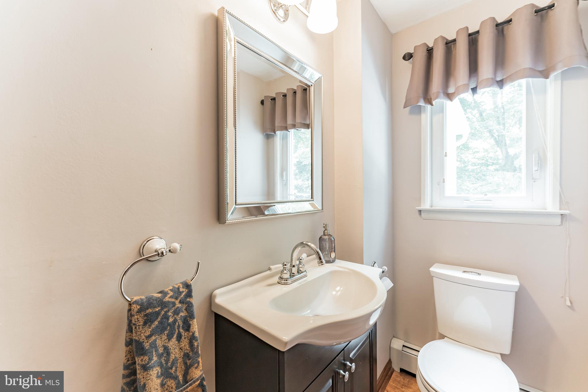 1070 Dale Road Media, PA 19063 - Photo 34 of 40 a bathroom with a toilet a sink and a mirror
