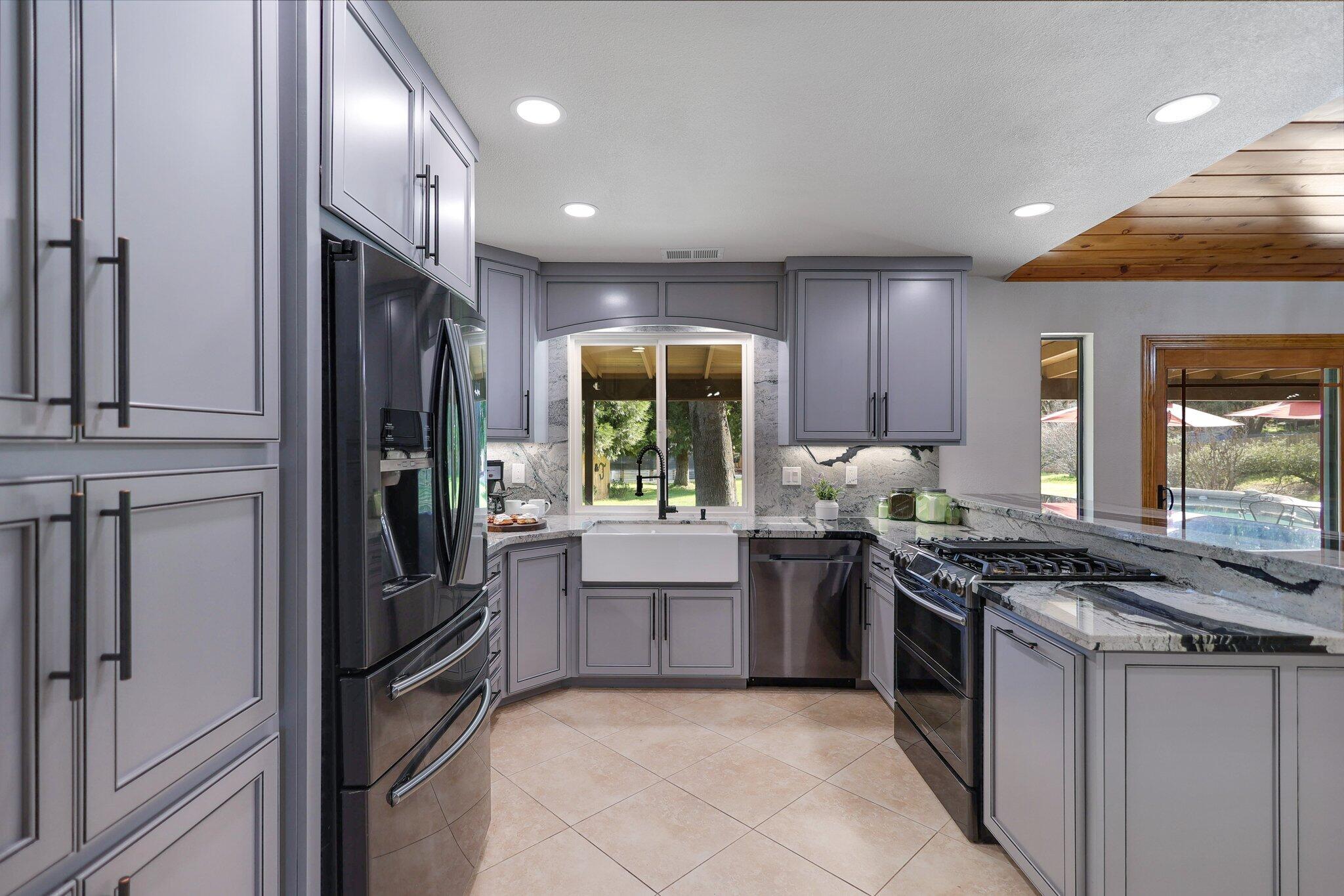 21365 Dersch Road Anderson, CA 96007 - Photo 12 of 55 a kitchen with stainless steel appliances granite countertop a stove a sink and a refrigerator