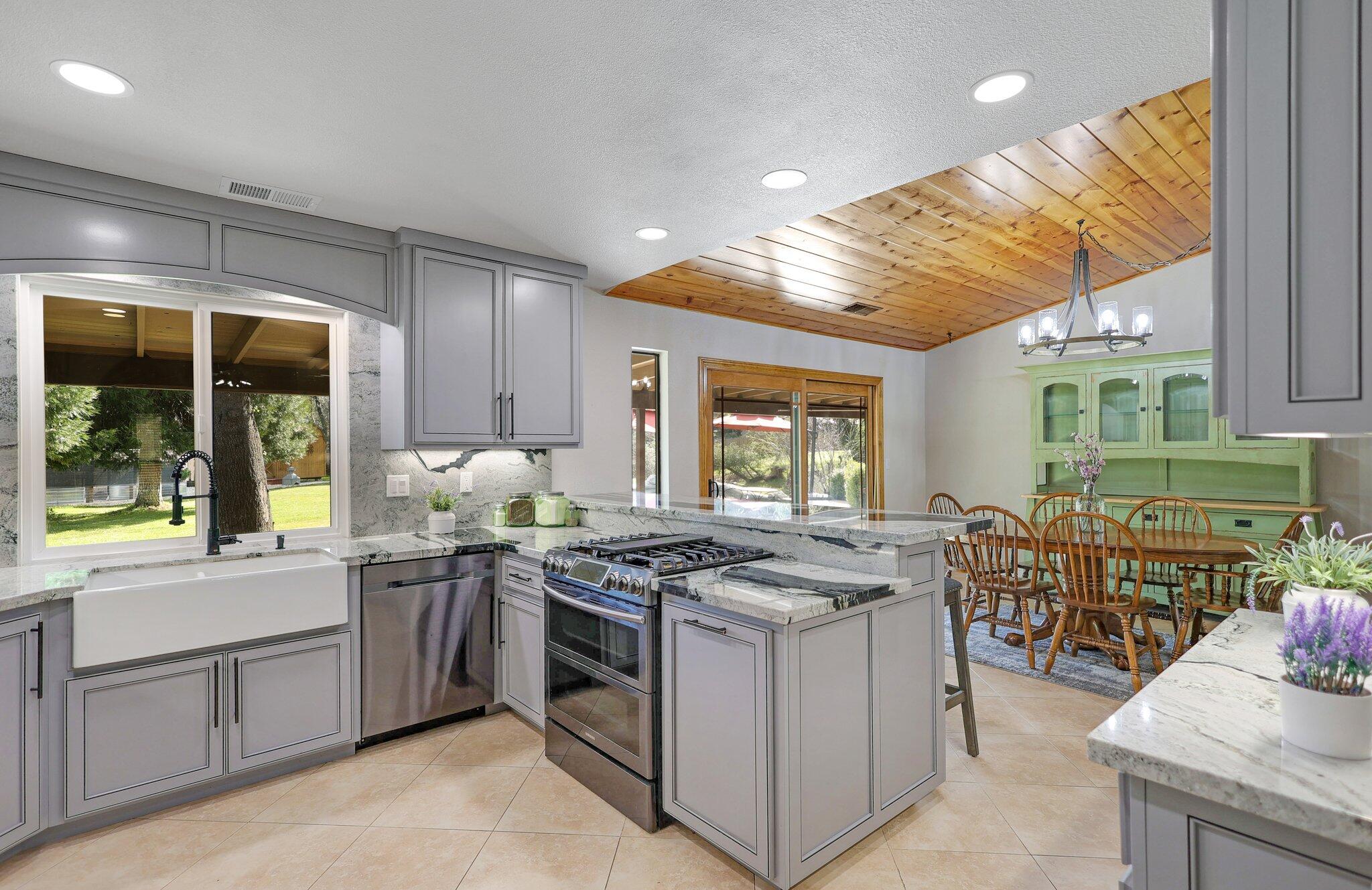 21365 Dersch Road Anderson, CA 96007 - Photo 13 of 55 a kitchen that has a lot of white cabinets and stainless steel appliances