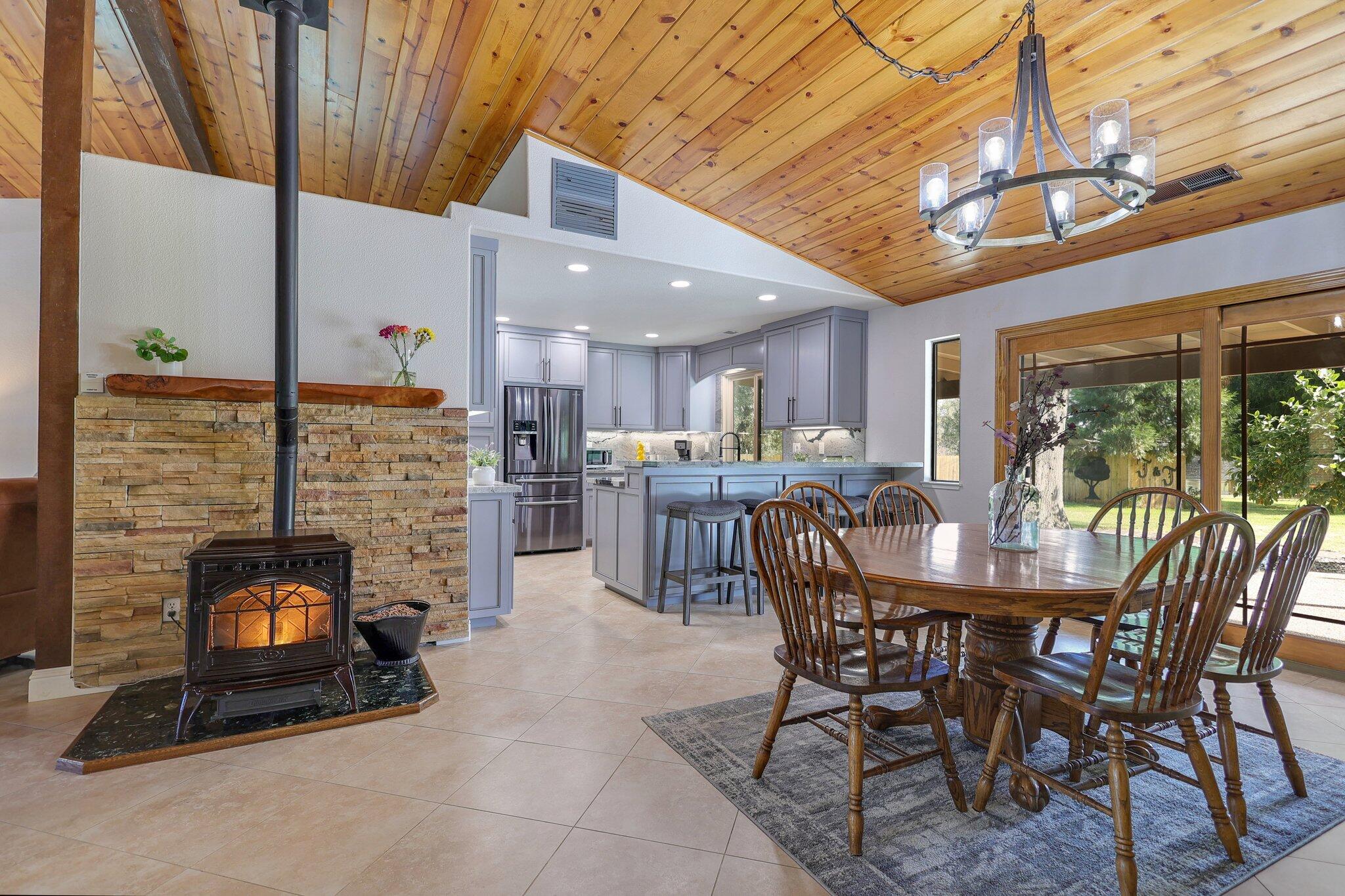 21365 Dersch Road Anderson, CA 96007 - Photo 17 of 55 a dining room with furniture a fireplace and window