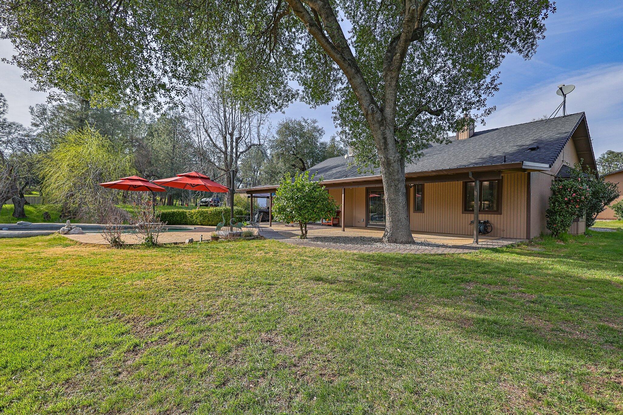 21365 Dersch Road Anderson, CA 96007 - Photo 37 of 55 a front view of a house with a garden and porch