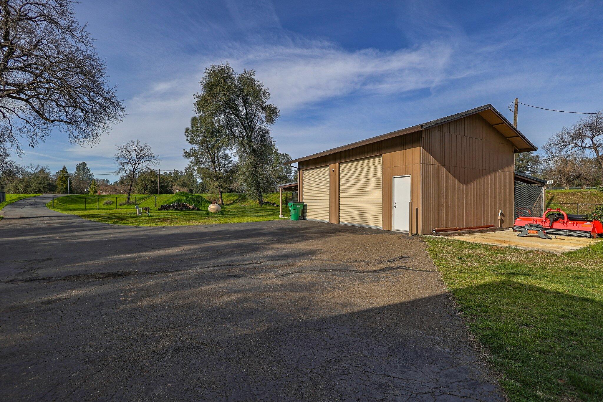 21365 Dersch Road Anderson, CA 96007 - Photo 43 of 55 a backyard of a house with lots of green space and outdoor seating