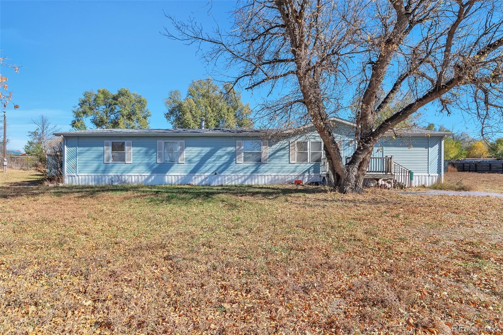 7702 Hart Street Fort Lupton, CO 80621 - Photo 1 of 25 a view of house with a yard