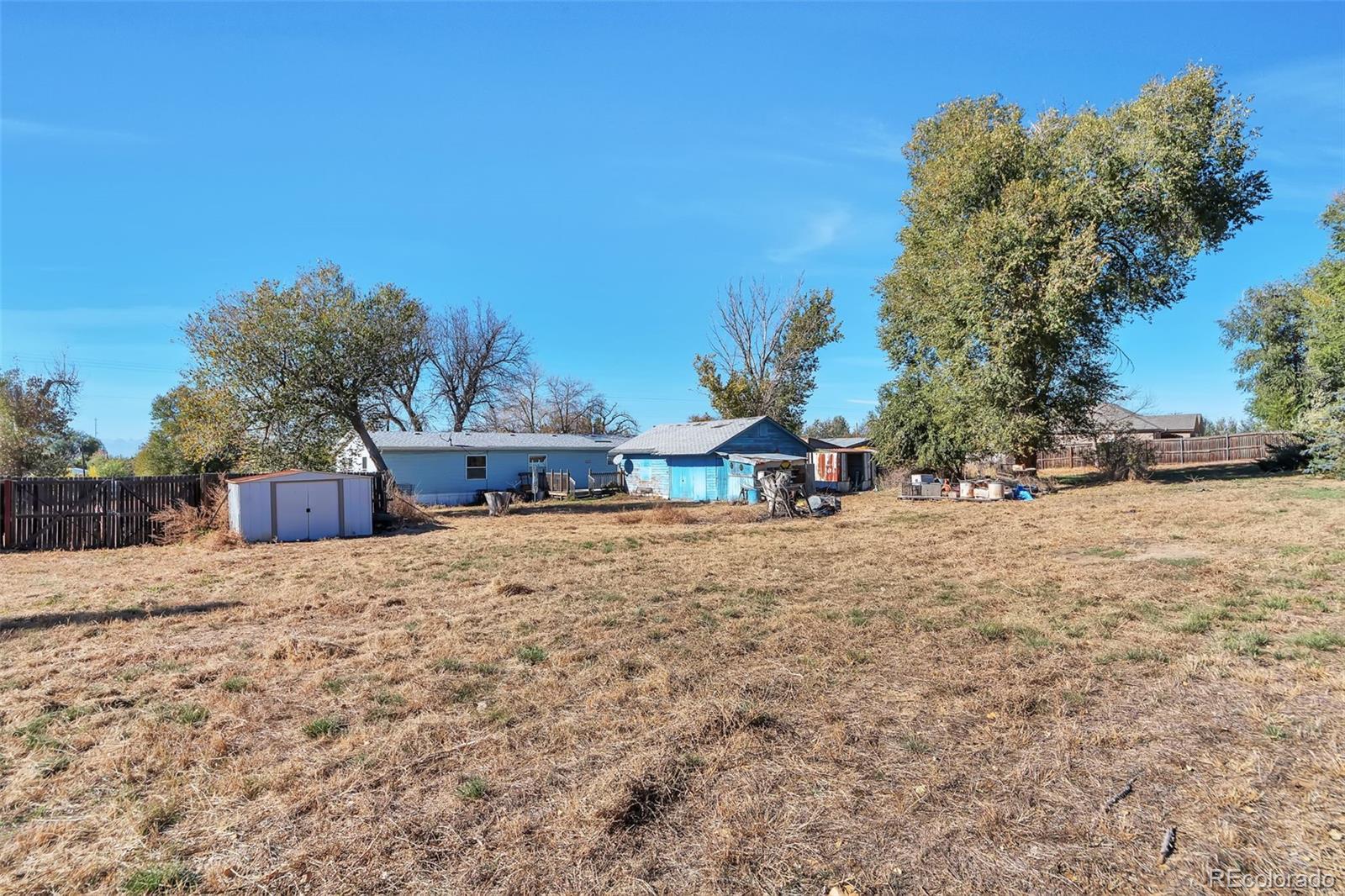 7702 Hart Street Fort Lupton, CO 80621 - Photo 2 of 25 a view of house with a yard and covered with snow