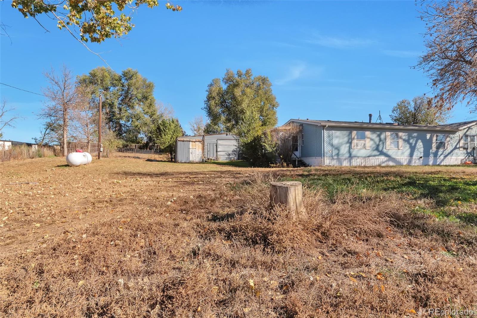 7702 Hart Street Fort Lupton, CO 80621 - Photo 25 of 25 a backyard of a house with lots of green space