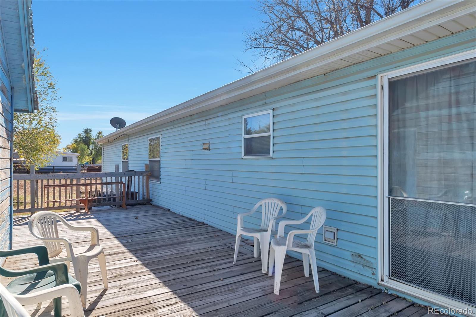 7702 Hart Street Fort Lupton, CO 80621 - Photo 3 of 25 a view of a chairs on deck