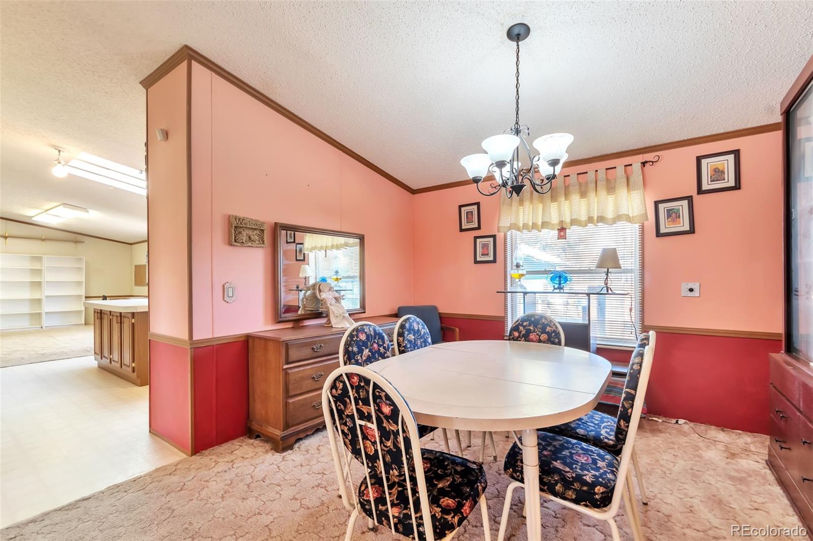 7702 Hart Street Fort Lupton, CO 80621 - Photo 7 of 25 a view of a dining room with furniture
