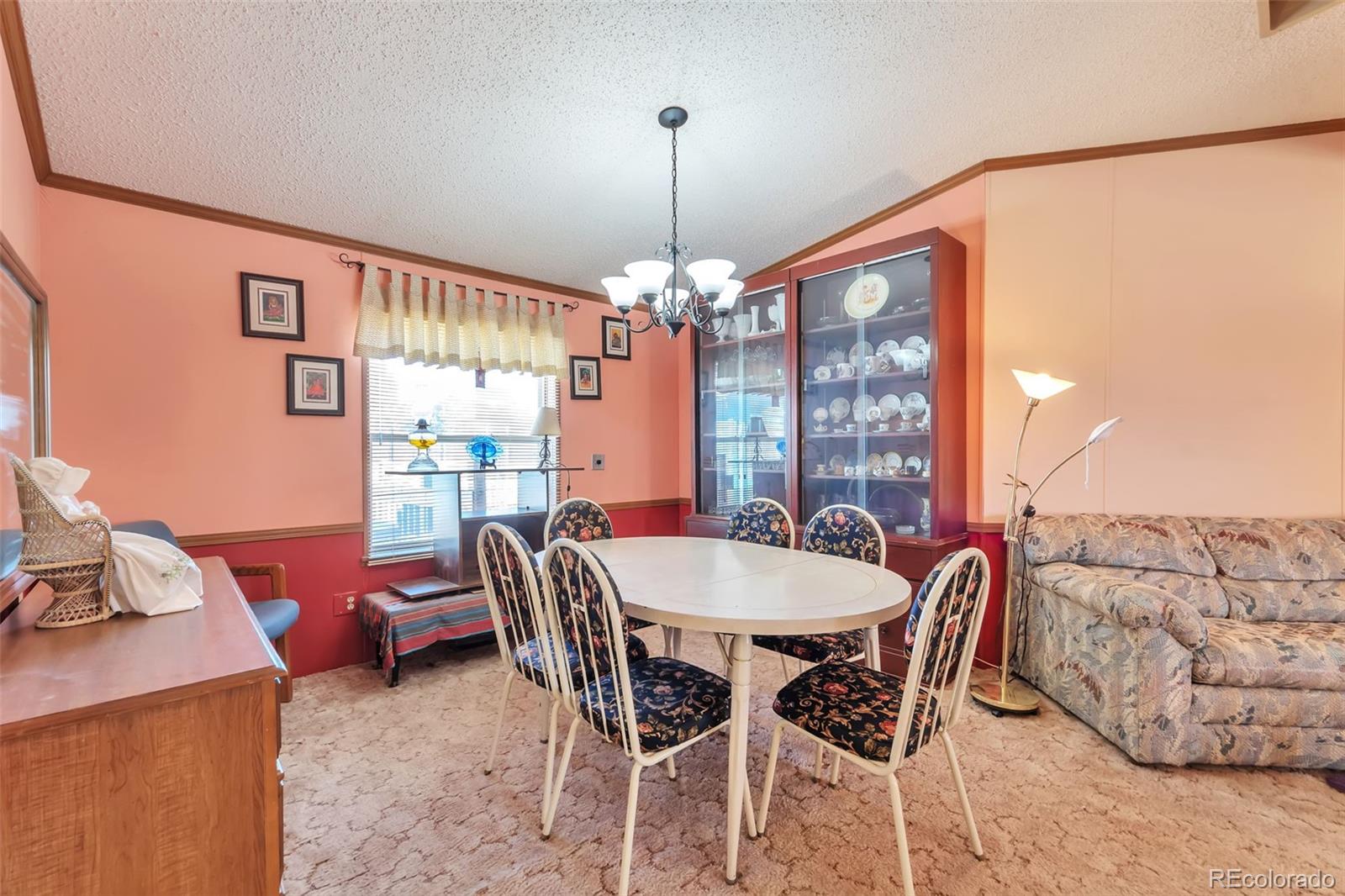 7702 Hart Street Fort Lupton, CO 80621 - Photo 8 of 25 a dining room with furniture and window
