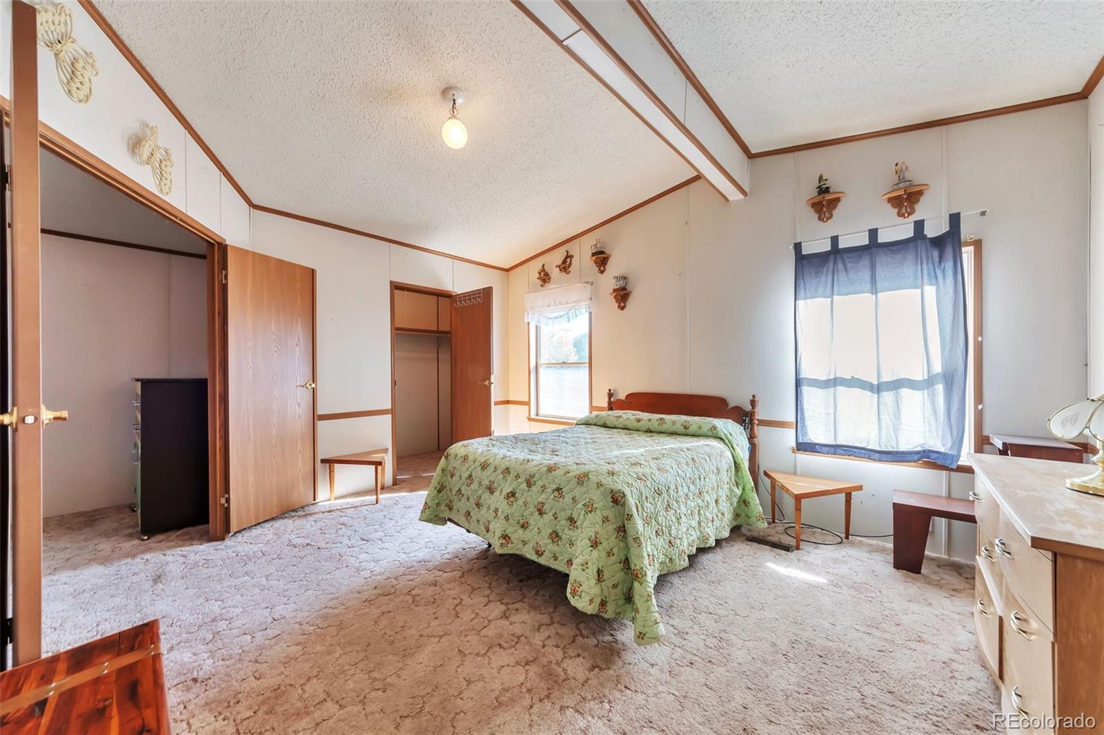 7702 Hart Street Fort Lupton, CO 80621 - Photo 9 of 25 a bedroom with a bed and a window
