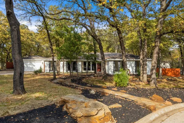 a view of a large trees in front of a house