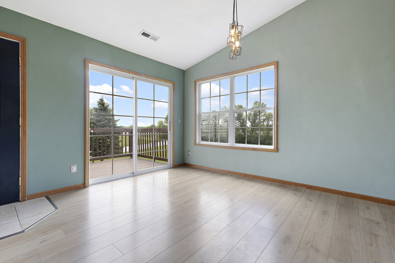 10050 Skipperling Road, Unit 1 Roscoe, IL 61073 - Photo 3 of 15 a view of an empty room with wooden floor and a window