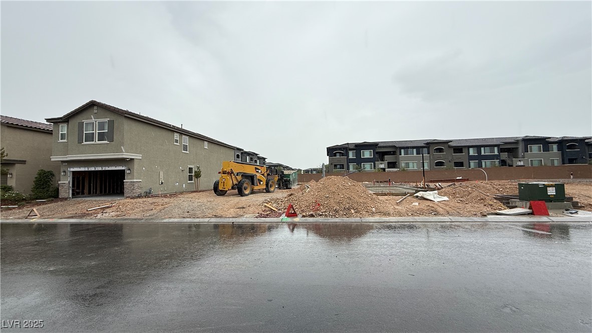 View of asphalt street featuring curbs