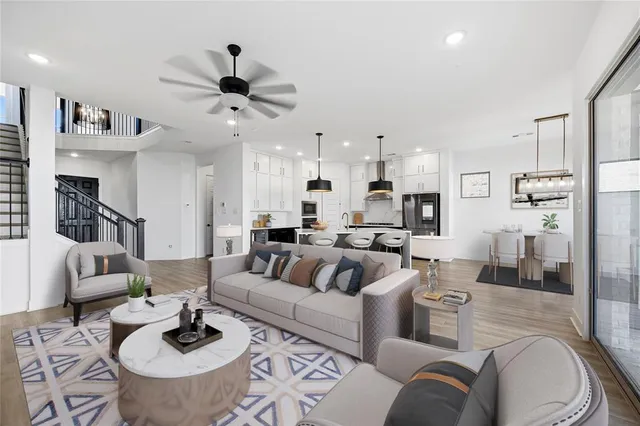 a living room with furniture and a view of kitchen