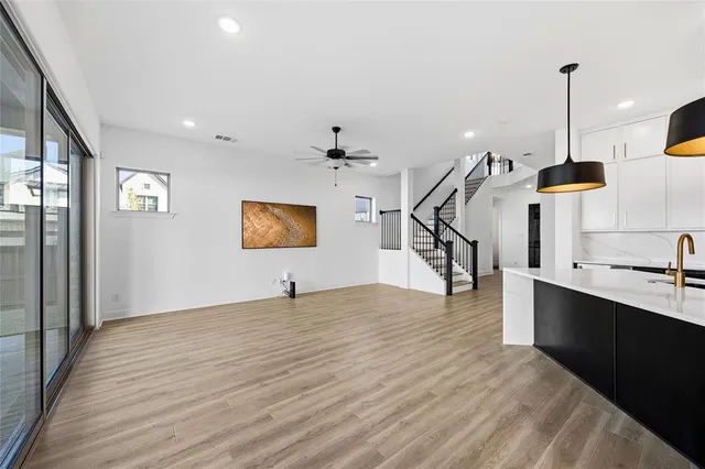 a view of a room with gym equipment and wooden floor