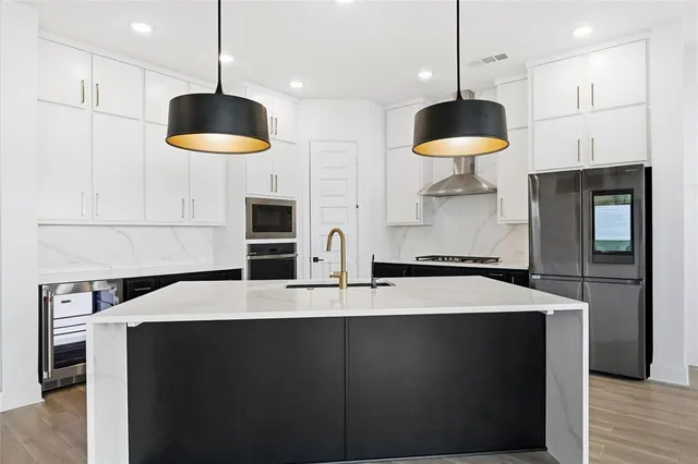 a large kitchen with cabinets wooden floor and a fireplace