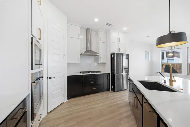 a large kitchen with cabinets wooden floor and a fireplace