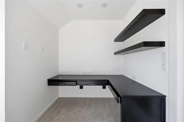 a kitchen with kitchen island granite countertop a sink refrigerator and cabinets