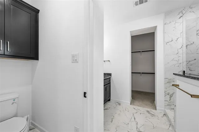 a view of room with ceiling fan and window