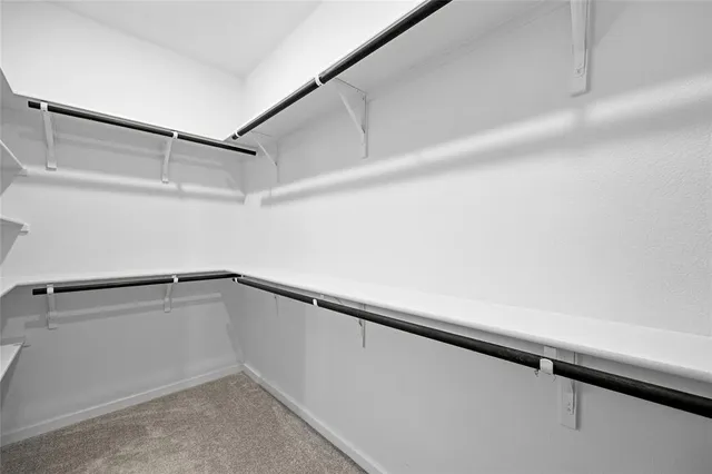 a bathroom with a granite countertop sink a mirror and shower