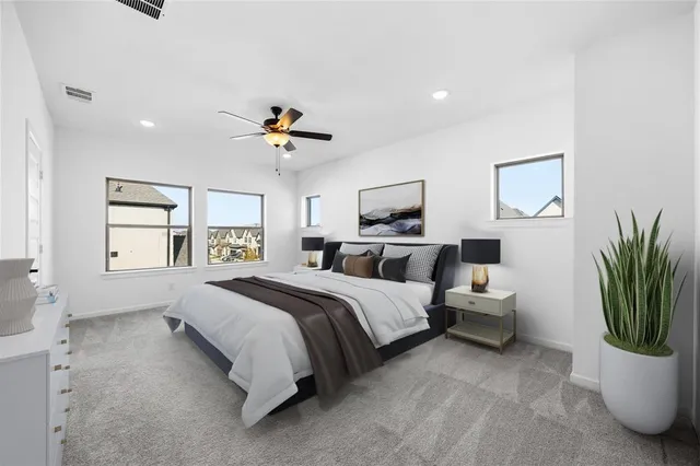 a spacious bedroom with a bed and a chandelier