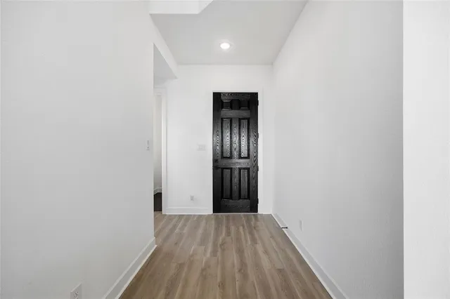 a view of hallway with wooden floor