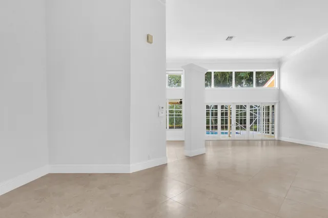 a kitchen with a sink window and cabinets
