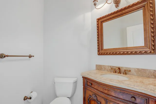 a kitchen with stainless steel appliances granite countertop a refrigerator a oven and white cabinets