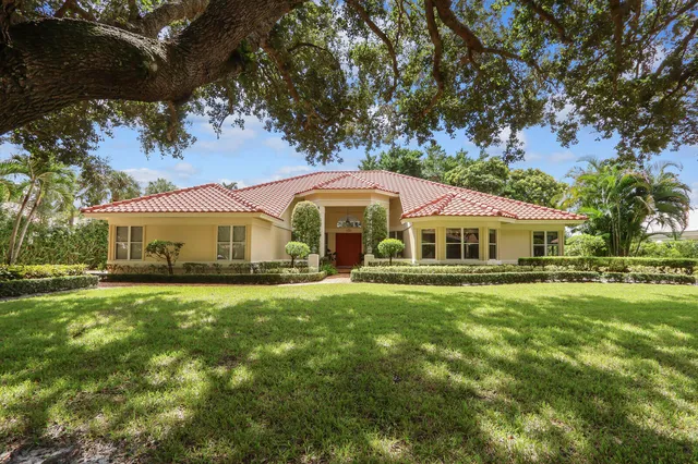a front view of house with yard and green space