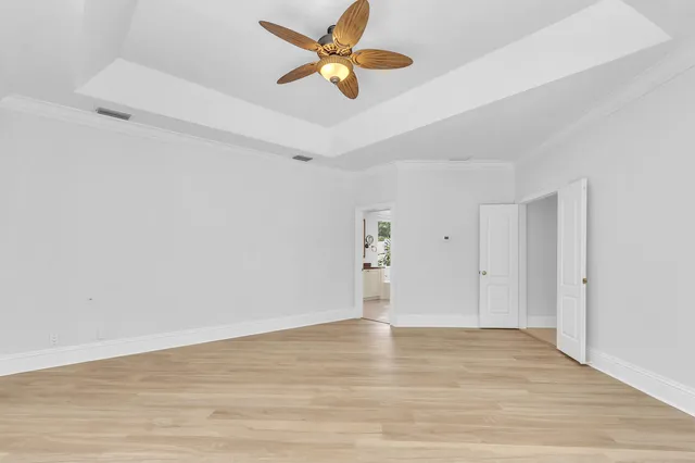 a view of a backyard with table and chairs and wooden fence