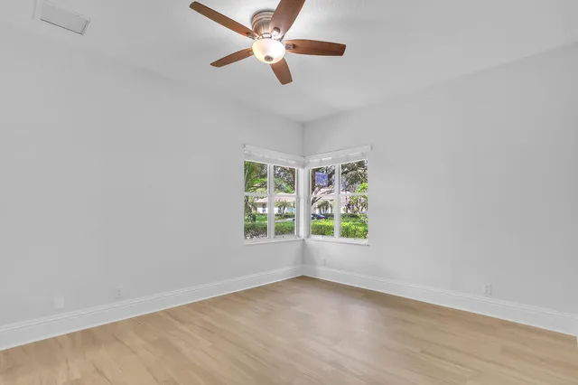 an aerial view of residential house with outdoor space and trees all around