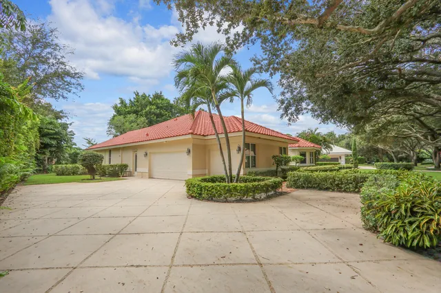 a brick house with potted plants in front of it