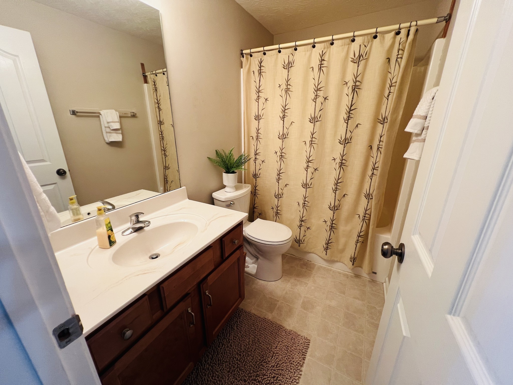 364 Dixie Lane Pleasant View, TN 37146 - Photo 41 of 45 a bathroom with a sink a toilet and shower curtain